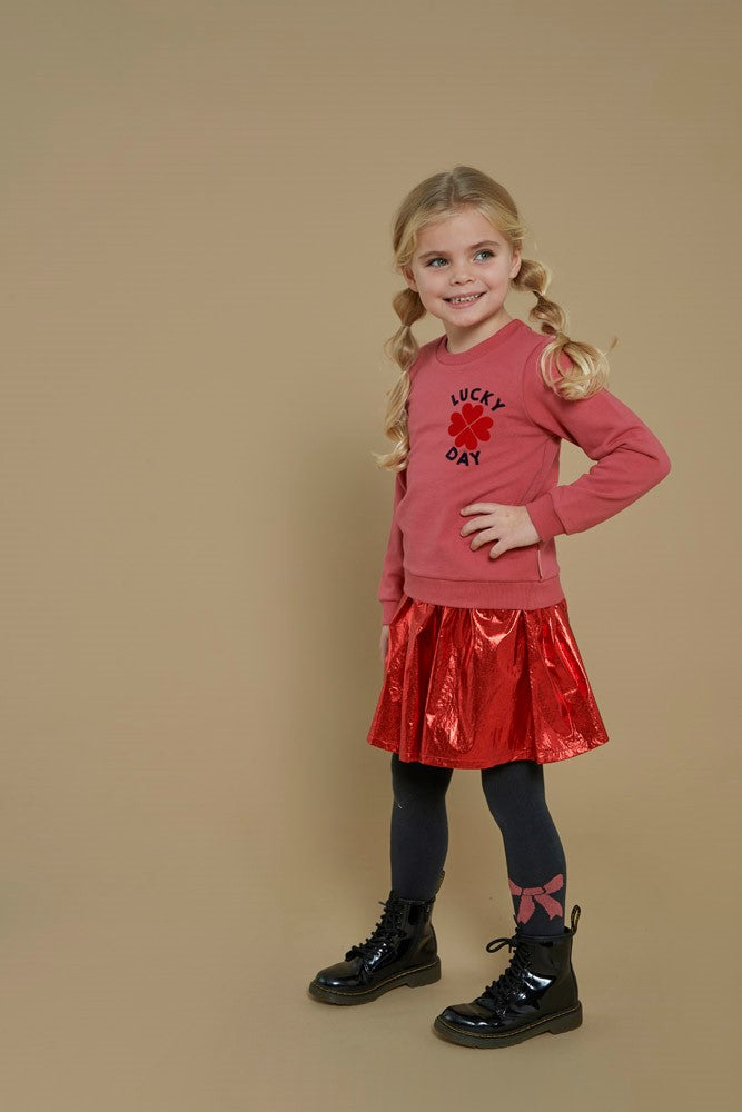 Jubel Sweater - Queen Of Hearts Sfeerfoto: "Kind draagt de Jubel Sweater - Queen Of Hearts in Roze, met een speelse hartprint, perfect voor een casual winteroutfit."